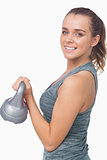 Happy woman training with a kettle bell