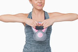 Mid section of young woman training with kettle bell