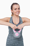 Cheerful woman working with a kettle bell