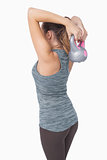 Lovely young woman training with a kettle bell