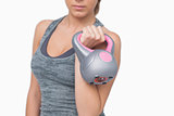 Mid section of young woman working with kettle bell