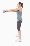 Young woman working with a kettle bell