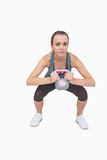 Attractive fit woman working with a kettle bell