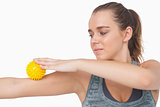 Woman using a massage ball for her arms