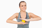 Happy woman holding yellow massage ball between her hands