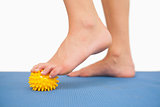 Close up of female feet touching yellow massage ball