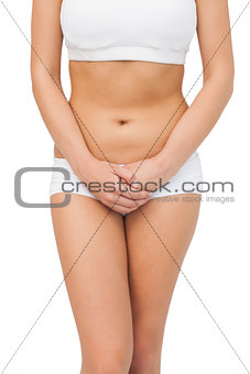 Slim young woman wearing a sports bra posing
