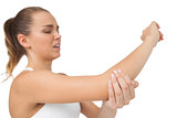 Suffering young woman touching her sore elbow