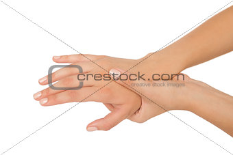 Young woman touching her injured hand
