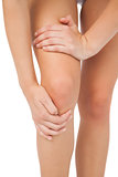 Close up of slim woman touching her injured knee