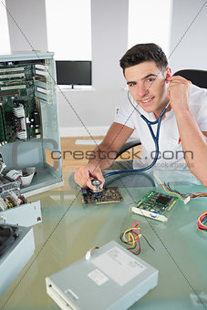 Handsome cheerful computer engineer holding stethoscope