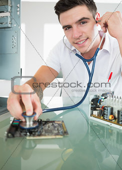 Handsome joyful computer engineer holding stethoscope