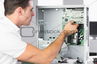 Handsome computer engineer working at open computer