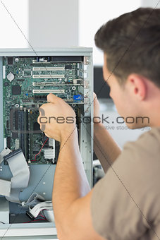 Computer engineer repairing computer