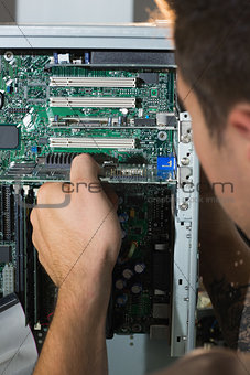 Computer engineer checking open computer