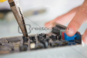 Extreme close up of pliers repairing hardware
