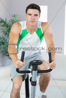 Handsome man training on exercise bike