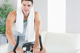 Content handsome man training on exercise bike