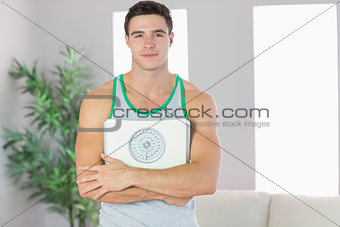 Content handsome man holding scales