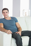 Smiling handsome casual man relaxing on couch