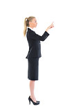 Profile view of young business woman pointing