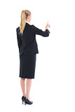 Young blonde businesswoman pointing