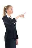 Side view of beautiful blonde businesswoman pointing