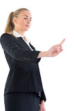 Low angle view of young businesswoman pointing upwards
