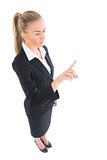 High angle view of blonde businesswoman pointing upwards