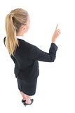 High angle view of young business woman pointing