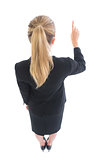 High angle rear view of blonde business woman pointing