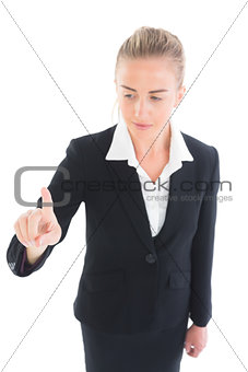 Smiling young business woman pointing