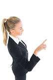 Blonde ponytailed business woman pointing
