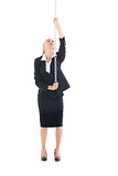 Front view of businesswoman climbing a chain