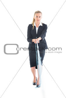 Serious young businesswoman using a hose