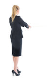 Rear view of standing business woman pulling a rope
