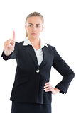 Focused young business woman pointing upwards