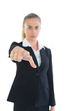 Attractive businesswoman pointing at camera