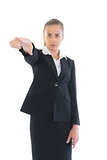 Focused young businesswoman pointing