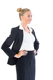 Happy young businesswoman posing with hands on hips