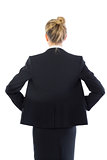 Rear view of young blonde businesswoman posing