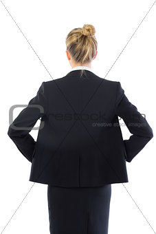 Rear view of young blonde businesswoman posing