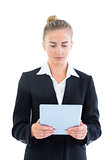 Profile view of concentrated young businesswoman using her tablet