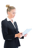 Side view of attractive businesswoman working with her tablet