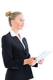 Side view of cheerful young businesswoman holding her tablet