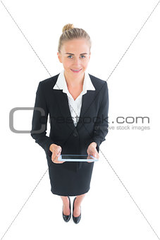 High angle front view of attractive young businesswoman holding her tablet