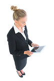 High angle side view of smart businesswoman using her tablet