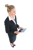 High angle side view of cheerful businesswoman holding her tablet