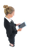 Profile view of attractive young businesswoman using her tablet