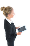 Profile view of young businesswoman holding her tablet